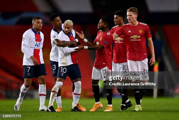 Neymar of Paris Saint Germain is held back by Presnel Kimpembe of Paris Saint Germain after clashing with Fred of Manchester United during the UEFA...