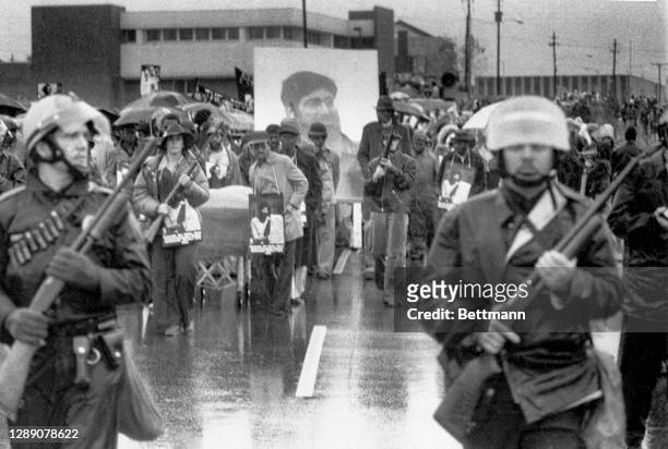 Armed police escort at a funeral march for five Communist Workers Party members killed on 11/3 in a shootout with Ku Klux Klansmen and Nazis. The...