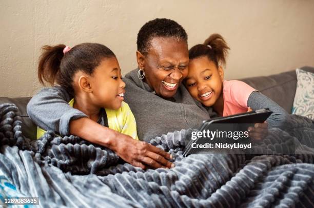 enjoying some bedtime entertainment - grandma sleeping stock pictures, royalty-free photos & images