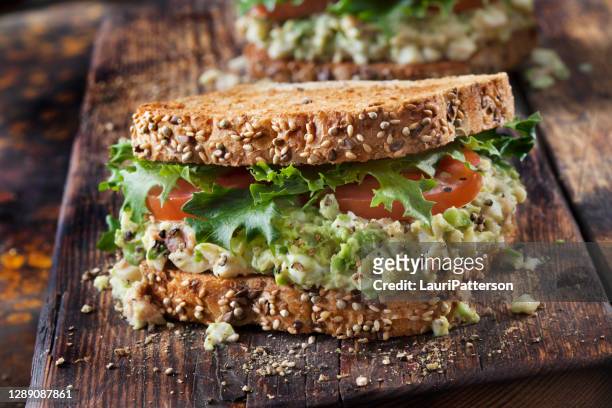 avocado and egg salad sandwich with crispy bacon, lettuce and tomato - whole wheat sandwich stock pictures, royalty-free photos & images
