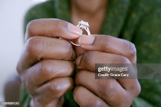 woman holds ring - engagement ring stock pictures, royalty-free photos & images