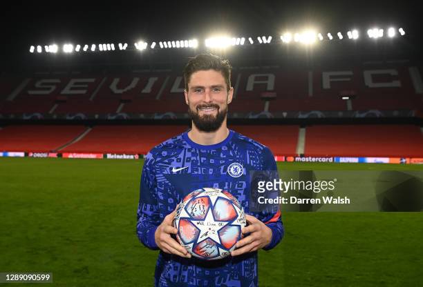 Olivier Giroud of Chelsea poses with the match ball after scoring four goals during the UEFA Champions League Group E stage match between FC Sevilla...
