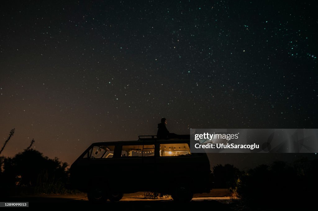 Motorhome on campsite at night. Can use for summer or holiday concept background.