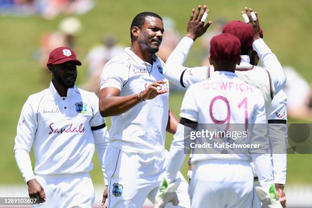 Shannon Gabriel of the West Indies is congratulated by team mates after dismissing Will Young of New Zealand during day one of the First Test match...