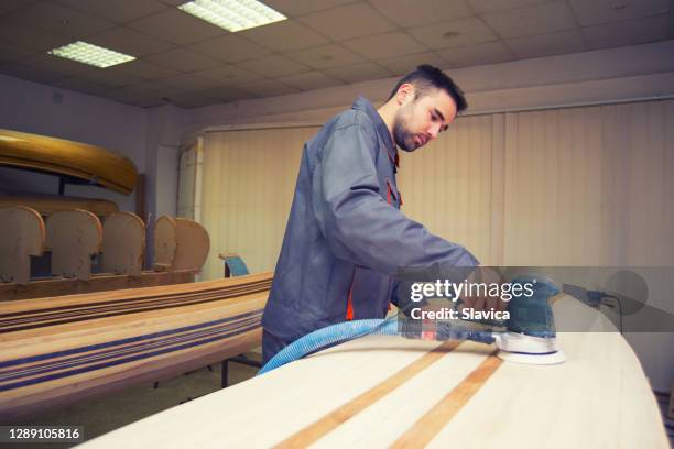 carpenter making canoe - sand paper stock pictures, royalty-free photos & images