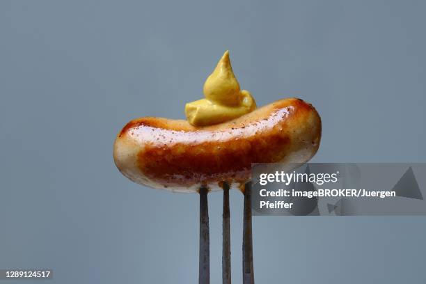 chipolata sausages with mustard on fork, switzerland - chipolatas stock pictures, royalty-free photos & images