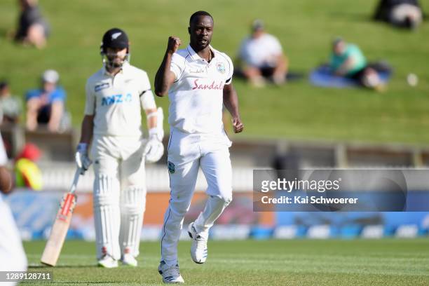 Kemar Roach of the West Indies celebrates after dismissing Tom Latham of New Zealand during day one of the First Test match in the series between New...