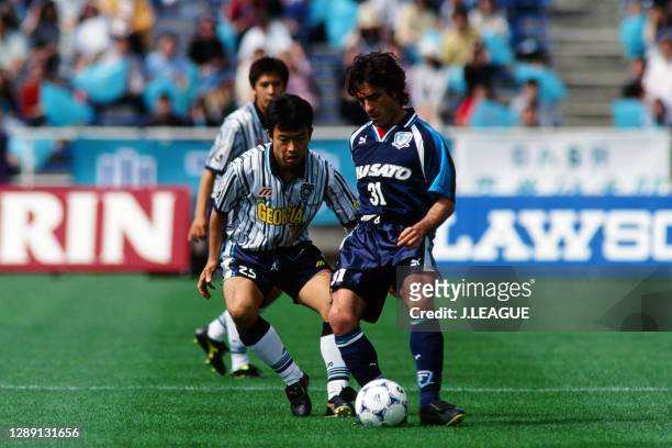 Paulo Futre of Yokohama Flugels controls the ball under pressure of Yuji Okuma of Avispa Fukuoka during the J.League first stage match between Avispa...