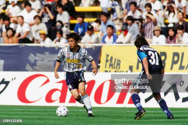 Tatsunori Hisanaga of Avispa Fukuoka takes on Paulo Futre of Yokohama Flugels during the J.League first stage match between Avispa Fukuoka and...