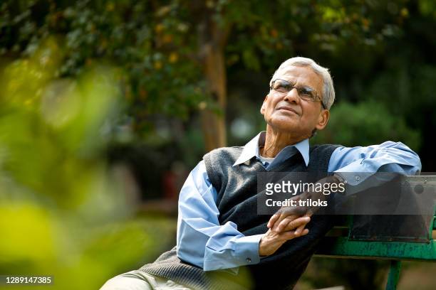 thoughtful senior man at park - senior adult stock pictures, royalty-free photos & images
