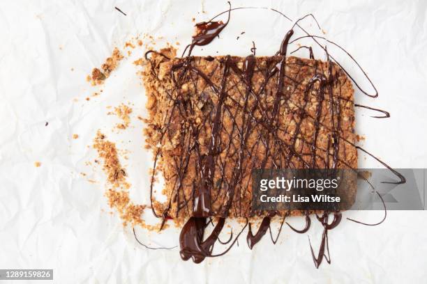 homemade flapjacks with chocolate drizzle - syrup drizzle stock pictures, royalty-free photos & images