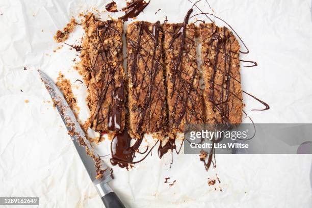 homemade flapjacks with chocolate drizzle - syrup drizzle stock pictures, royalty-free photos & images
