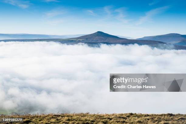 cloud inversion and view to sugar loaf;image taken from the skirrid in monmouthshire, south wales, uk. november - inversion_(meteorology) stock-fotos und bilder
