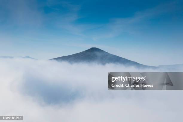 cloud inversion and view to sugar loaf;image taken from the skirrid in monmouthshire, south wales, uk. november - inversion_(meteorology) stock-fotos und bilder