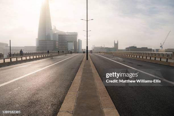 Quiet, empty and deserted roads and streets in London in Coronavirus Covid-19 pandemic lockdown at The Shard at London Bridge, with no traffic...