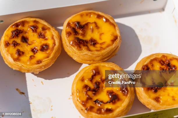 portuguese egg tarts in macau - pastel de nata stock pictures, royalty-free photos & images