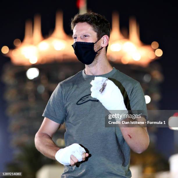 Romain Grosjean of France and Haas F1 walks in the Paddock with bandages on his burnt hands after his crash at the previous race during previews...