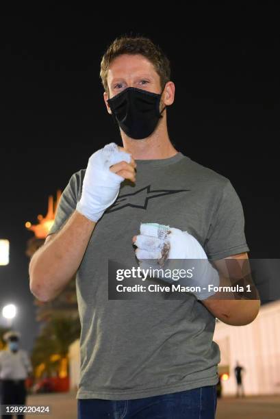 Romain Grosjean of France and Haas F1 walks in the Paddock with bandages on his burnt hands after his crash at the previous race during previews...
