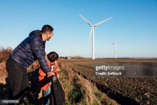 teaching his son about sustainability - social impact stock pictures, royalty-free photos & images