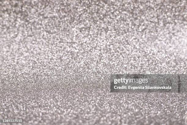 bright sparkle silver background. holiday and festive concept. - fokus-auf-den-hintergrund stock-fotos und bilder