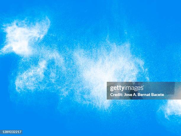 full frame of the textures formed  by the water jets to pressure with drops floating in the air on a blue background - aerosol can stock pictures, royalty-free photos & images