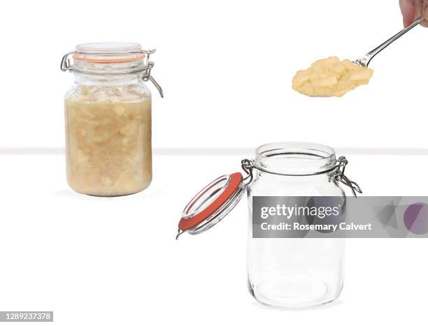 apple being spooned into jar, full jar in background. - pure white background bildbanksfoton och bilder