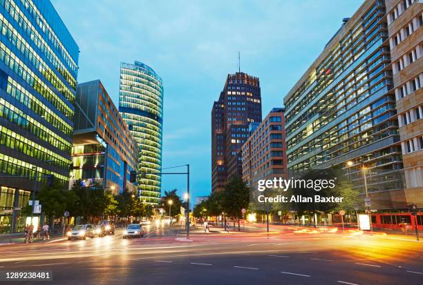 modern architecture along potsdamer strabe illuminated at dusk - postdamer platz stock pictures, royalty-free photos & images