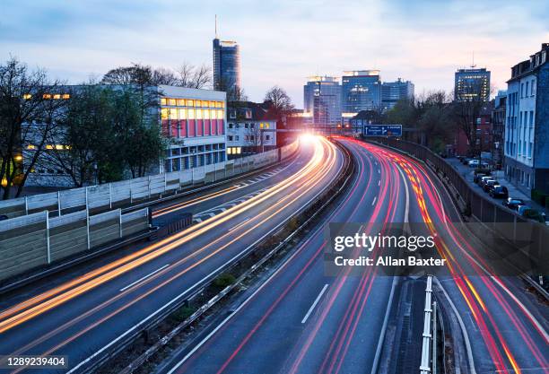 skyline of essen with highway at dusk - essen germany stock pictures, royalty-free photos & images