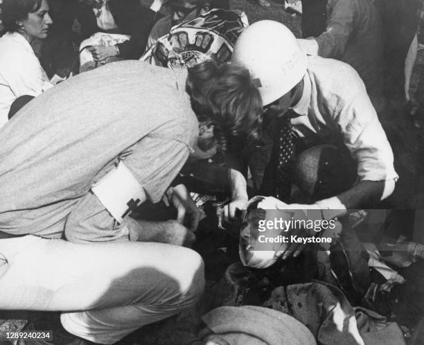 Medic wraps a bandage around the head of an injured protestor during the violent clashes at the 1968 Democratic National Convention, held in Chicago,...