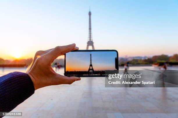 man photographing eiffel tower with smartphone, personal perspective view, paris, france - human hand photos stock pictures, royalty-free photos & images