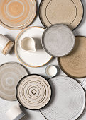 Top view of handmade ceramics, empty craft ceramic plates and cups.