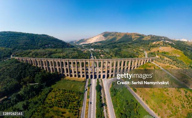 high resolution wide aerial view. the aqueduct of vanvitelli, caroline. valle di maddaloni, near caserta italy. 17th century. large stone structure for transporting water. viaduct. - roman landscapes stock pictures, royalty-free photos & images