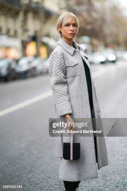 Anne-Sophie Mignaux-Kamar, wife of singer and artist Cyril Kamar "K-Maro", wears a Pellegrino "Soir de Paris" bejeweled bag, a gray wool long coat...