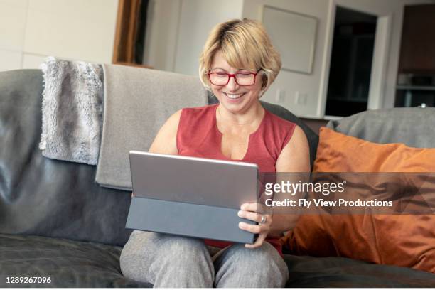 vrouw die tabletcomputer voor online medisch overleg gebruikt - film screening stockfoto's en -beelden