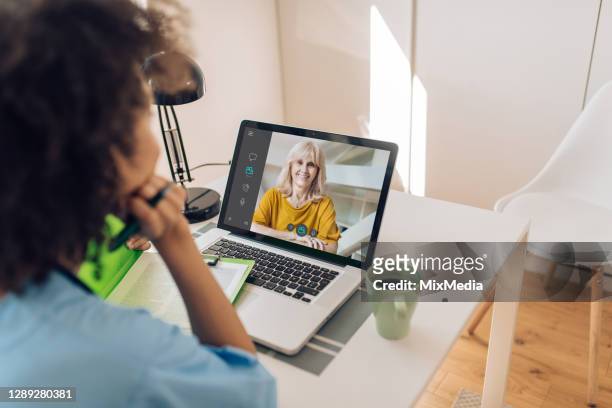 senior woman is having an online doctor checkup - distant meeting stock pictures, royalty-free photos & images