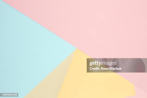 multi-colored paper geometric abstract background of yellow, blue and pink colors. - multi colored background bildbanksfoton och bilder