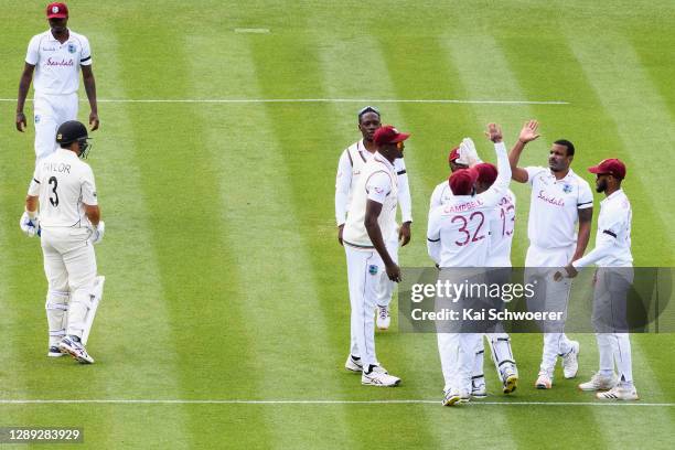 Shannon Gabriel of the West Indies is congratulated by team mates after dismissing Ross Taylor of New Zealand during day two of the First Test match...