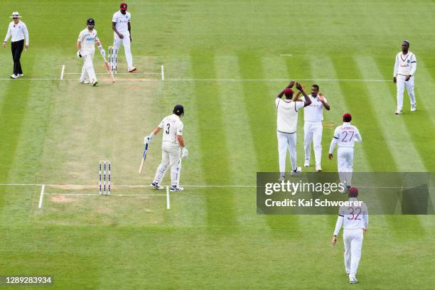 Shannon Gabriel of the West Indies is congratulated by team mates after dismissing Ross Taylor of New Zealand during day two of the First Test match...