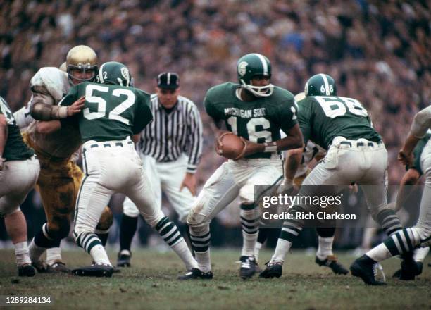 Quarterback Jimmy Raye of the Michigan State Spartans takes the snap against the Notre Dame Fighting Irish at Spartan Stadium on November 19, 1966 in...