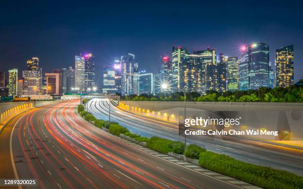 traffic trail and lights in downtown central - singapore - reflector stock-fotos und bilder