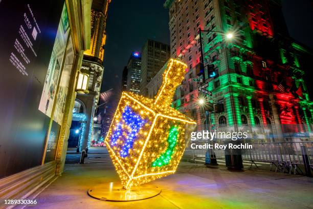 View of the "Whirl of Whimsy" sculpture in the shape of a dreidel honoring the Jewish holiday of Hanukkah displayed along Fifth Avenue on December...