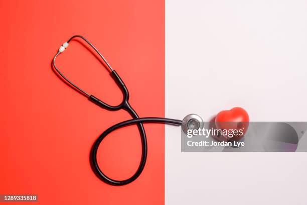 stethoscope with red heart - stethoscope stockfoto's en -beelden