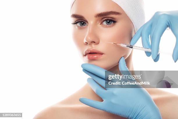 woman having facial injections - botox injection stock pictures, royalty-free photos & images