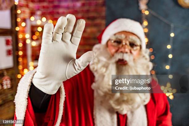 cheerful santa claus waving - santa waving stock pictures, royalty-free photos & images