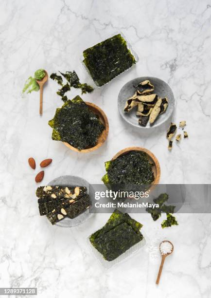 healthy wakame seaweed snacks nori algae with wasabi and almonds - seaweed stock pictures, royalty-free photos & images