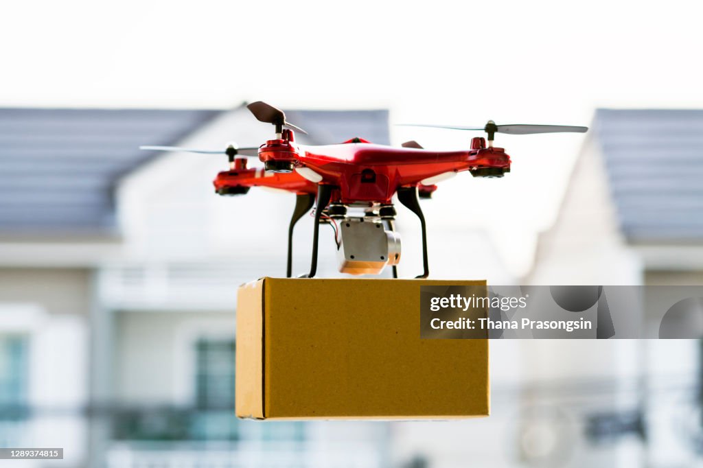Drone delivering package over cityscape