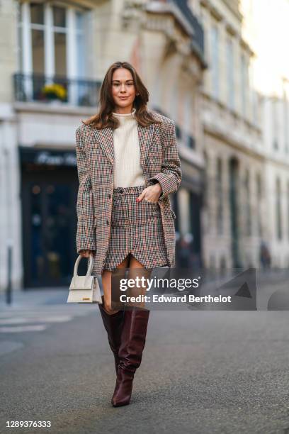 Therese Hellström wears a full Zadig & Voltaire look made of a white wool pullover, a checked houndstooth pattern oversized blazer jacket with long...