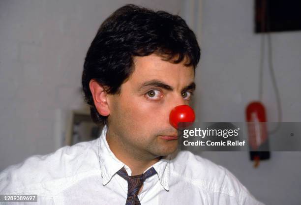 Rowan Atkinson poses with a red nose, on set for Red Nose Day 1988 on 25 January 1988 in London. .