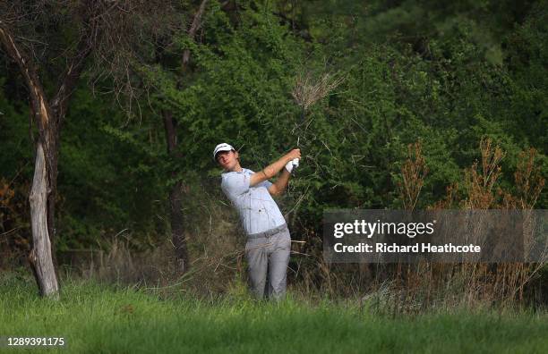 Nicolai Hojgaard of Denmark plays out the bushes for their second shot on the 18th hole during Day 2 of the South African Open at Gary Player CC on...