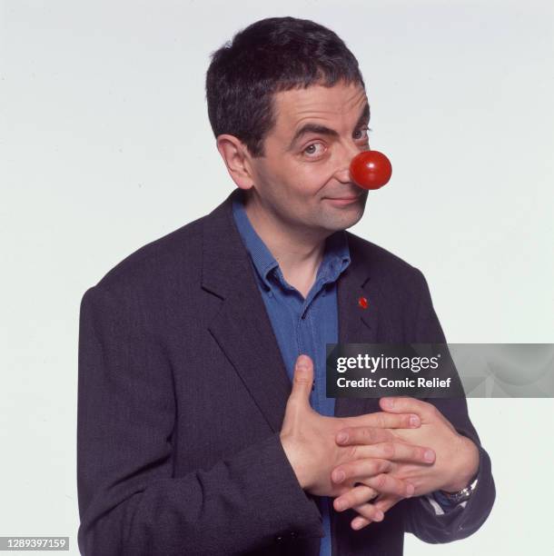 Rowan Atkinson wears 'the big red hooter' glitter red nose and red nose badge for red nose day 1999 in London, England."u2028"u2028